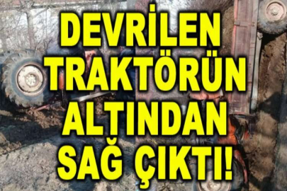 Devrilen traktörün altından sağ çıktı