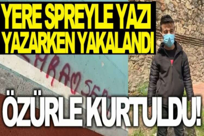 Yere spreyle yazı yazarken yakalandı, özürle kurtuldu